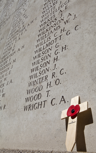 war memorial and cross with poppy